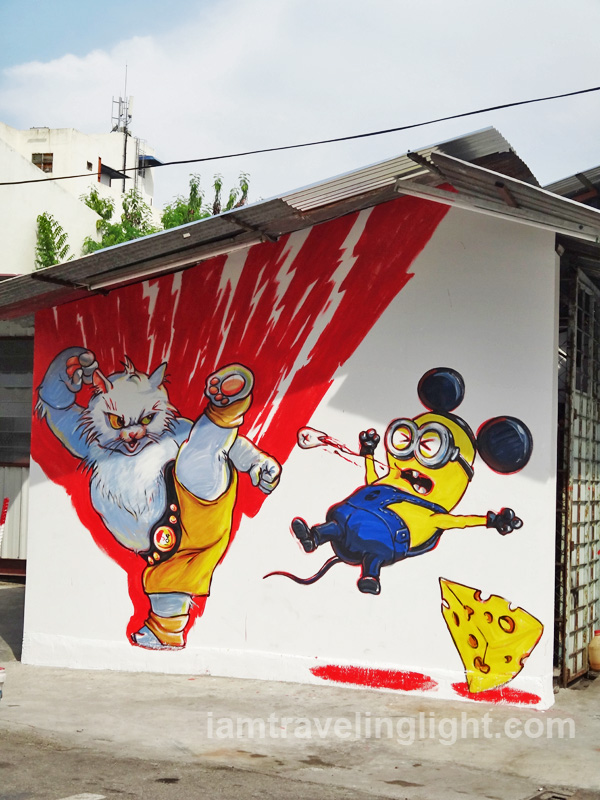 Cat fighting minion, cat street art, Penang, Malaysia