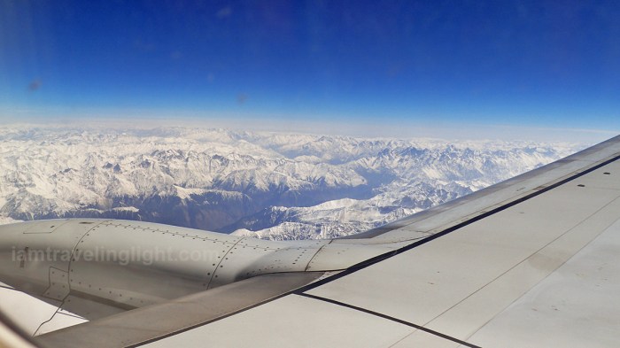 Himalayas mountain range medium shot, tail end winter, view from the plane, with aircraft wings, flight to Leh from New Delhi, India.jpg